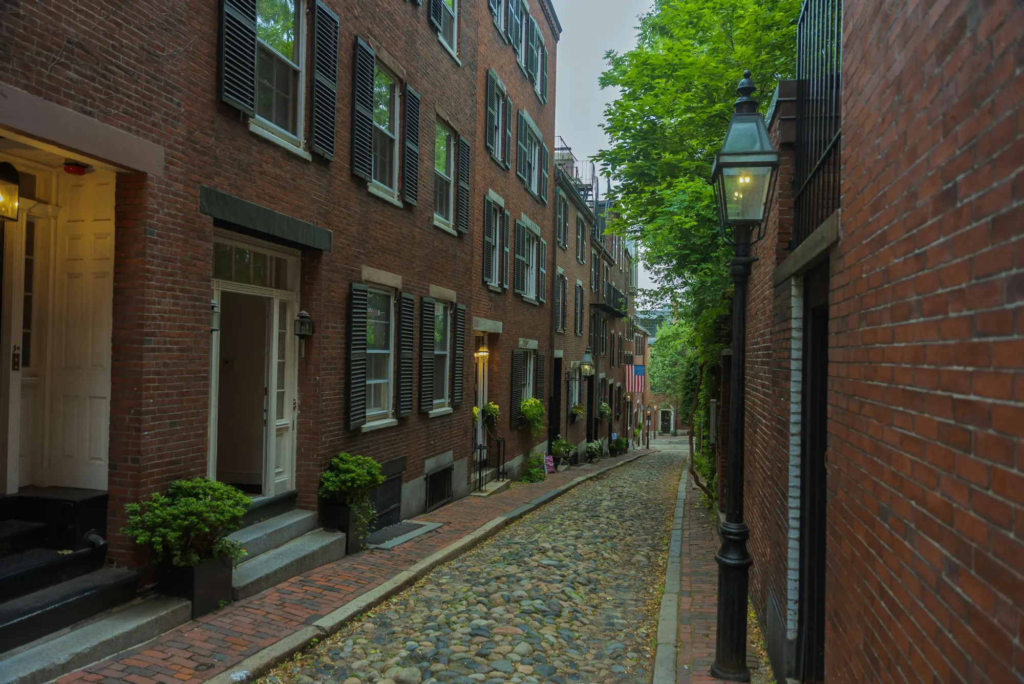 Brick rowhouses along a narrow cobblestone street