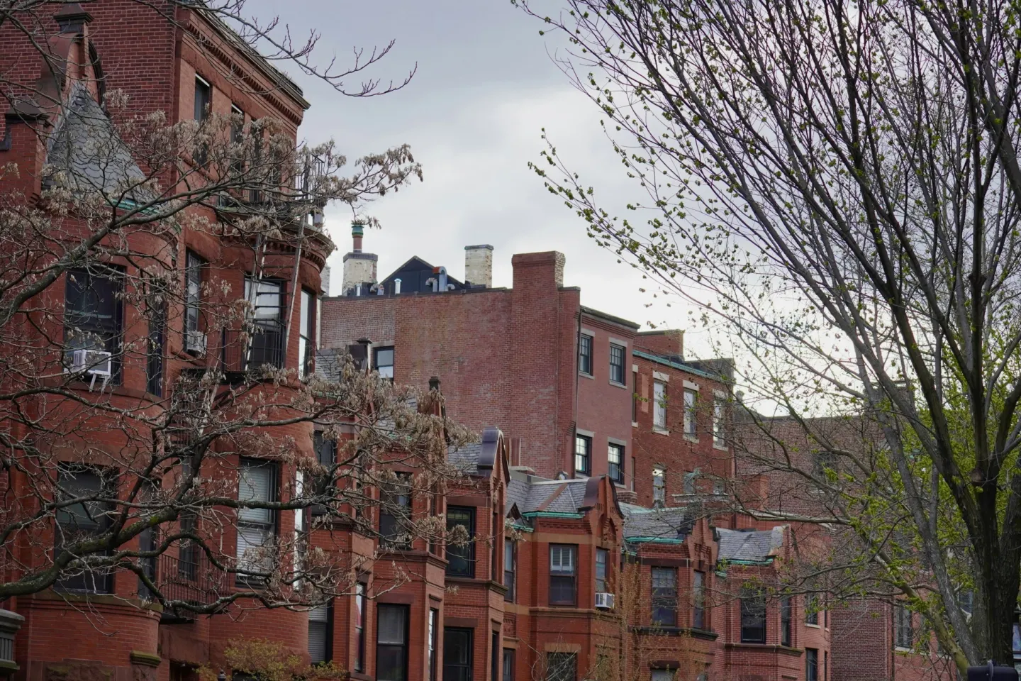 Row of brick townhouses with bay windows