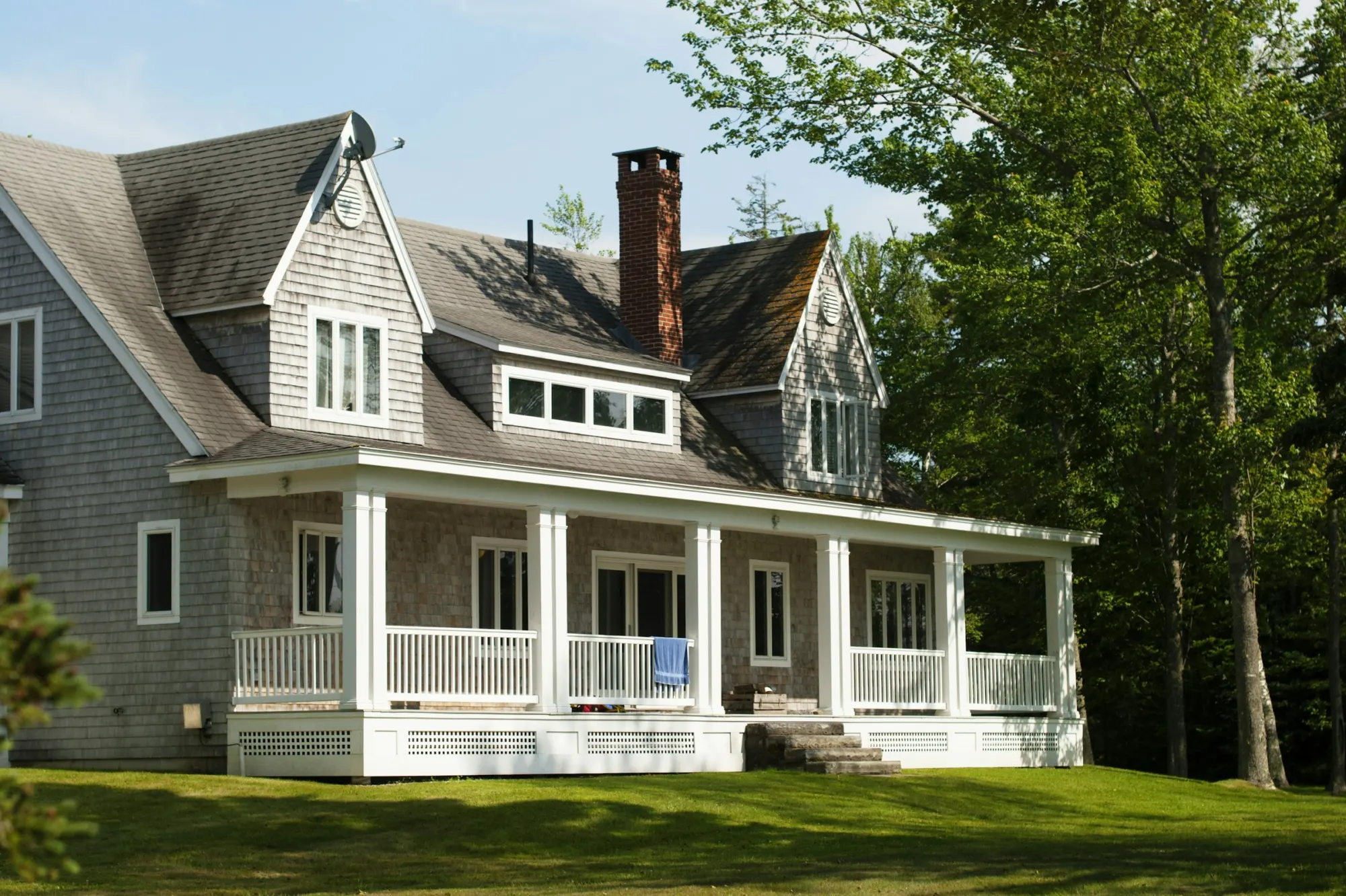 Shingle-style Victorian house with a wraparound porch