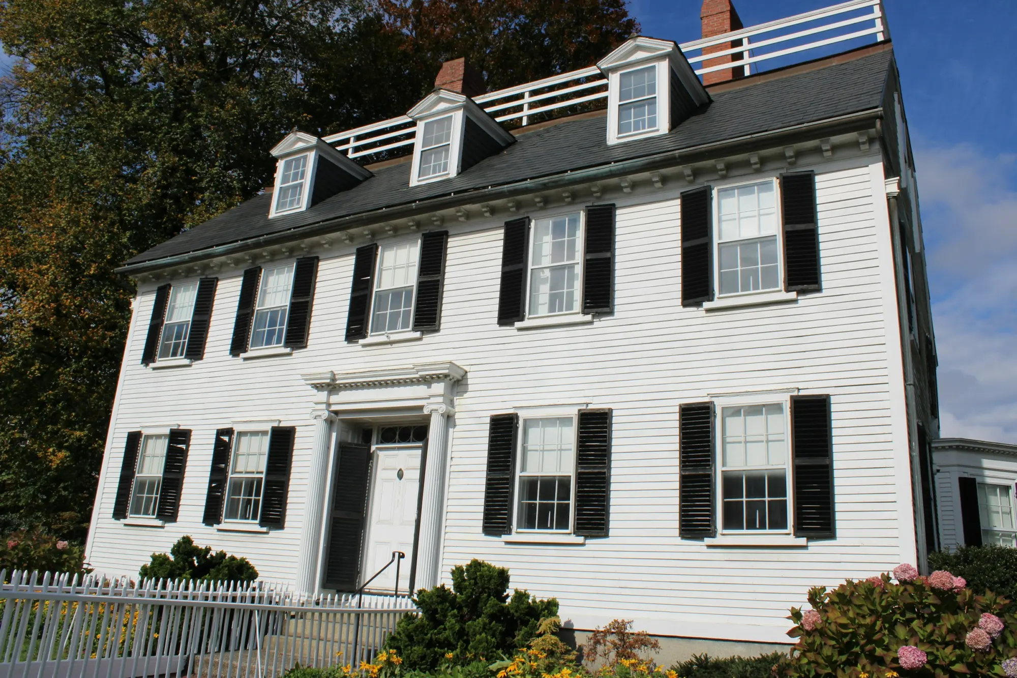 White colonial house with black shutters
