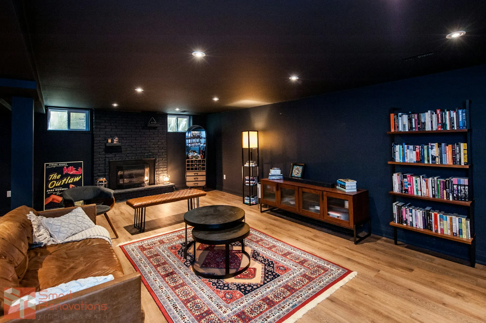 Finished lower-level den with built-in bookshelves and wood flooring