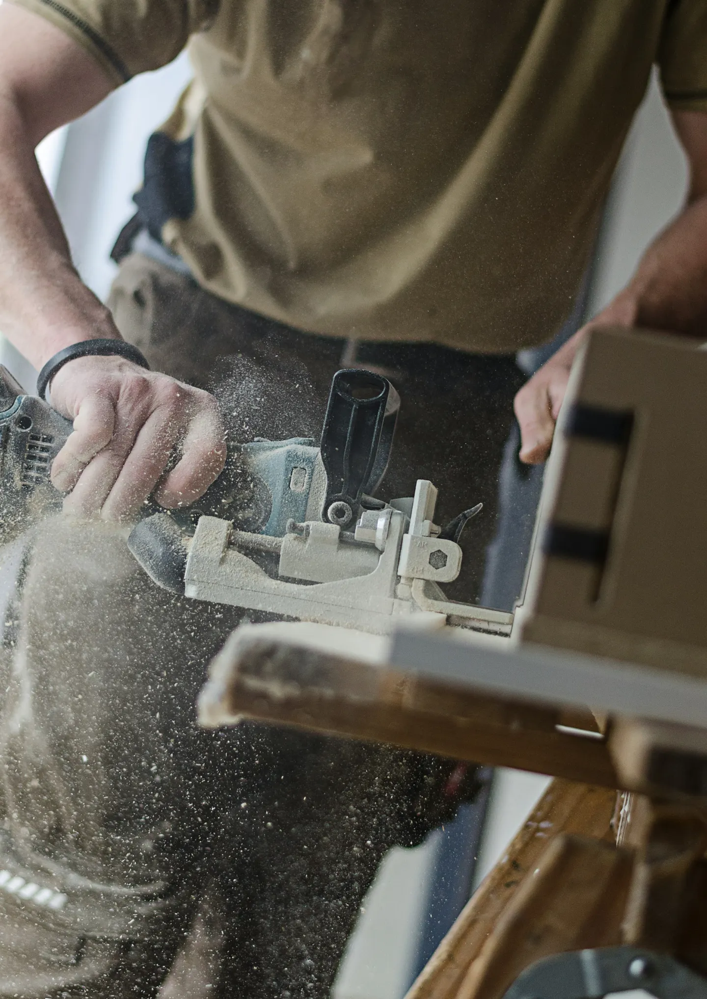 Carpenter cutting lumber with a saw
