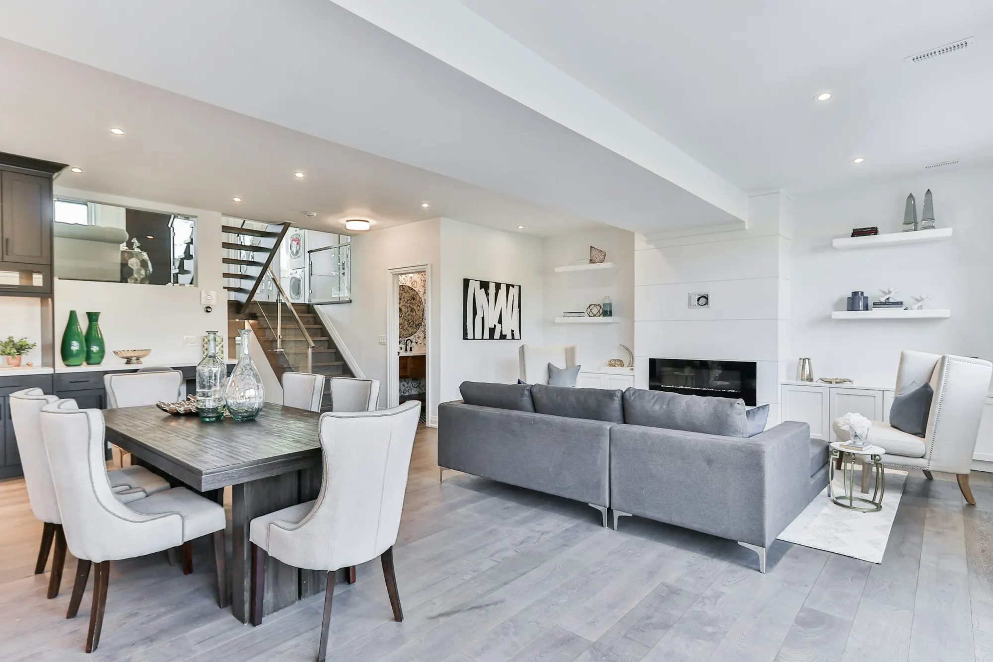 Open living and dining space with white walls and a modern fireplace